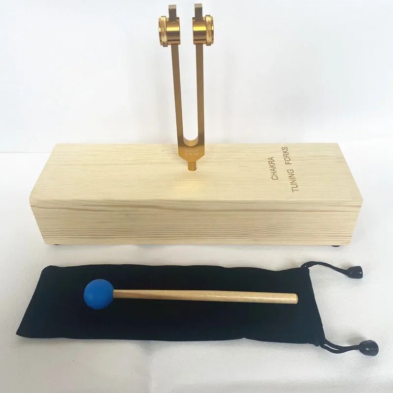 Tuning fork on wooden resonance box with mallet for Sacral Chakra Healing