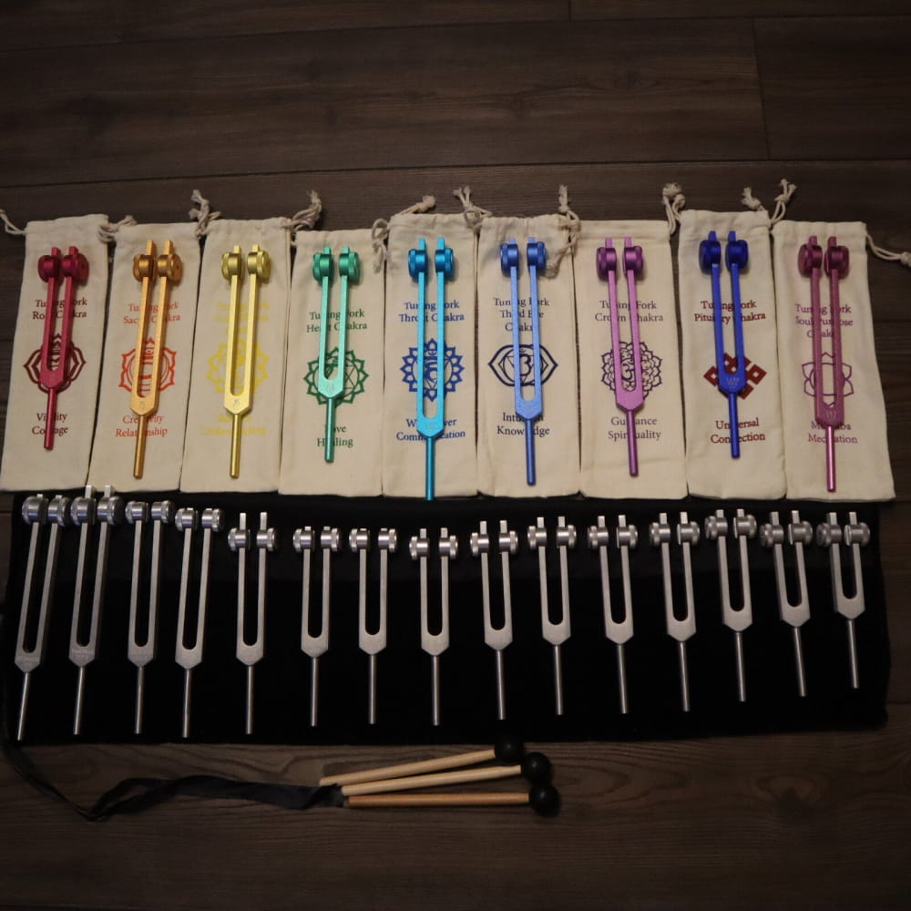 Collection of colorful tuning forks in a rainbow pattern for sound healing