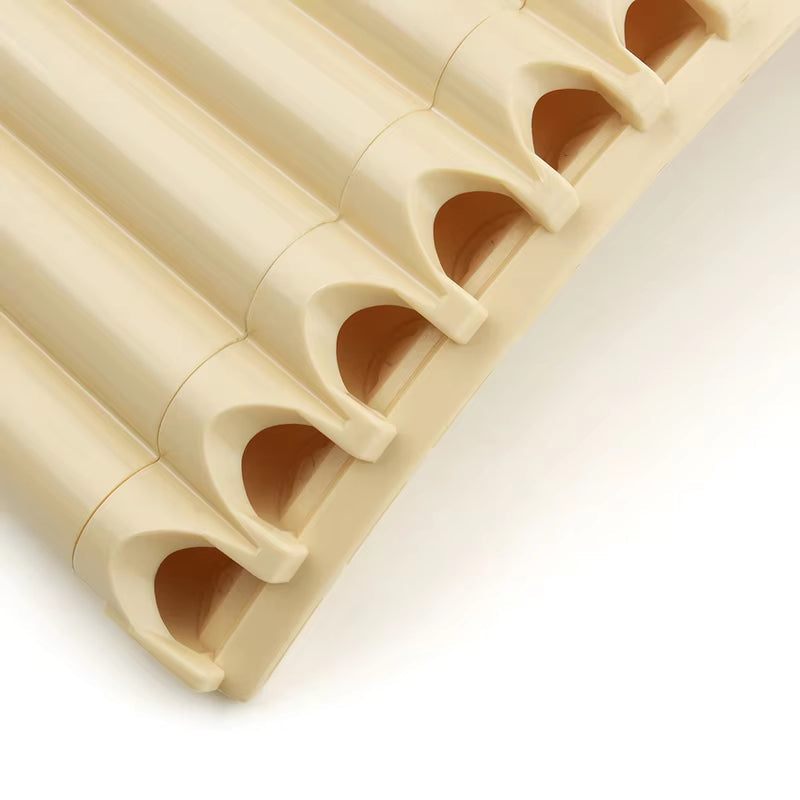 Row of cream-colored plastic pipe insulation tubes for 26-Pipe Pan Flute with Bag