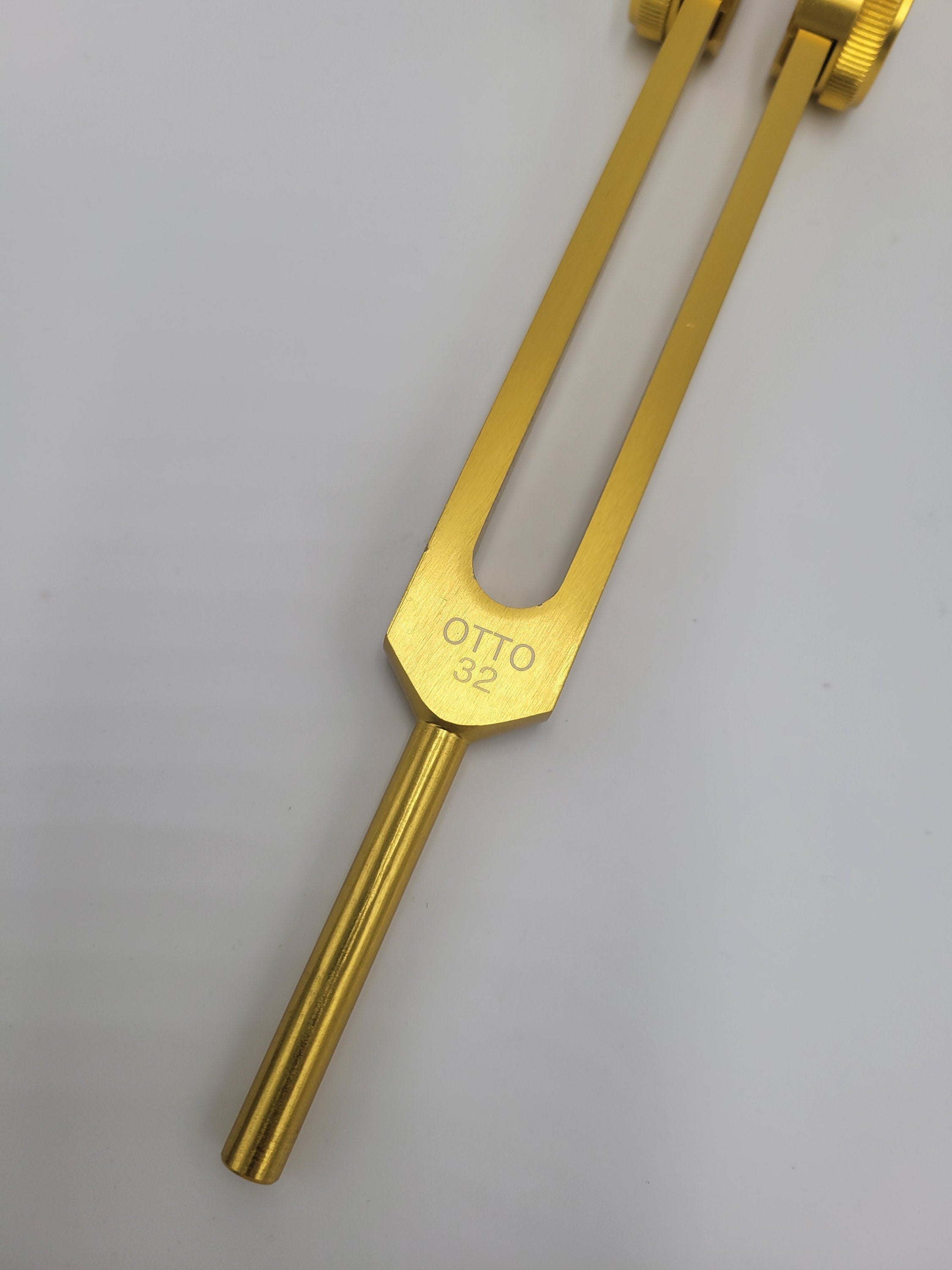 Golden tuning fork engraved with Otto for 32 Hz healing and therapy applications