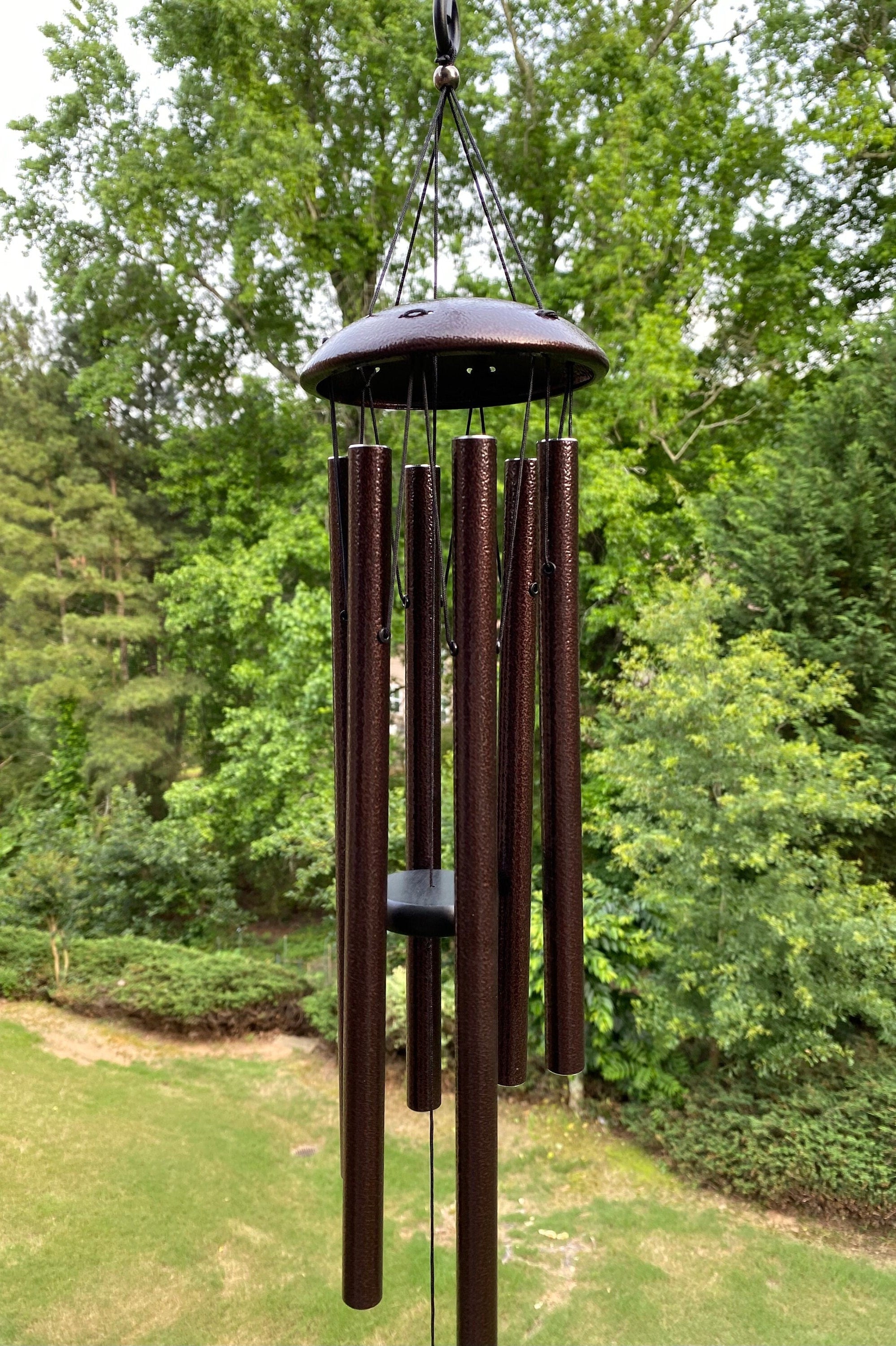 Dark metal wind chimes with long tubular bells for outdoor relaxation and ambiance