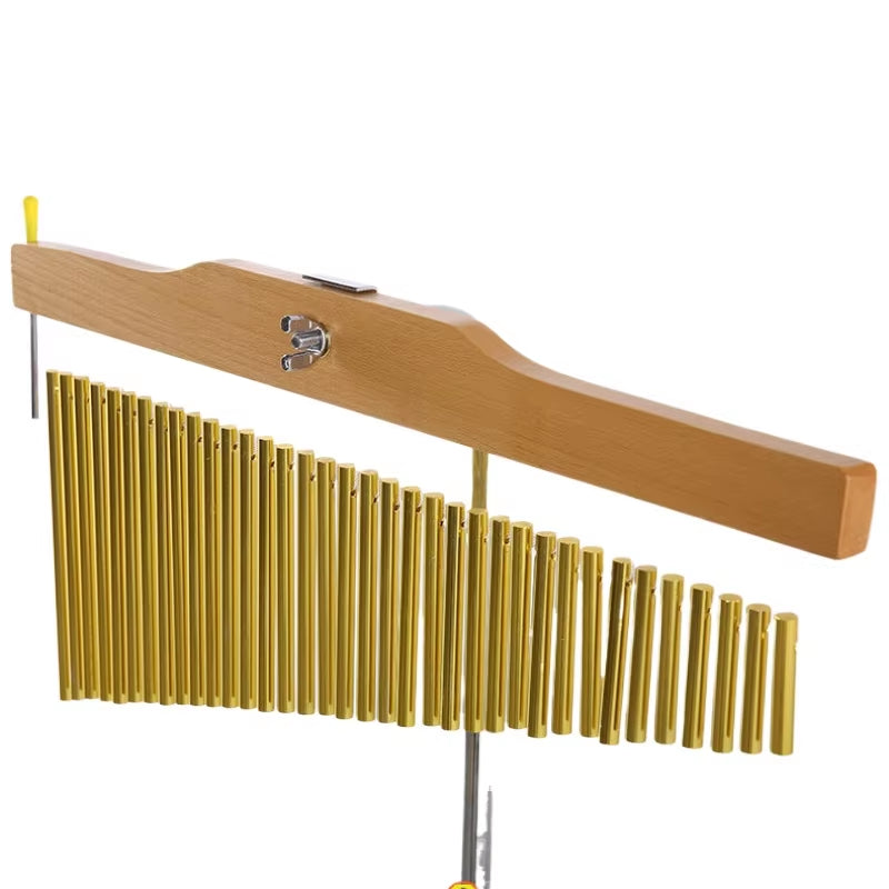 Golden chimes on wooden bar stand for yoga and meditation relaxation