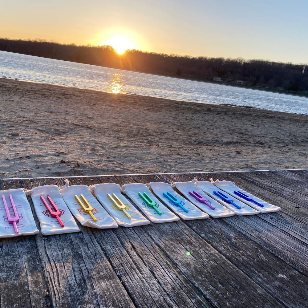 Colorful popsicle sticks on wooden decking alongside Tuning Fork Set for Healing