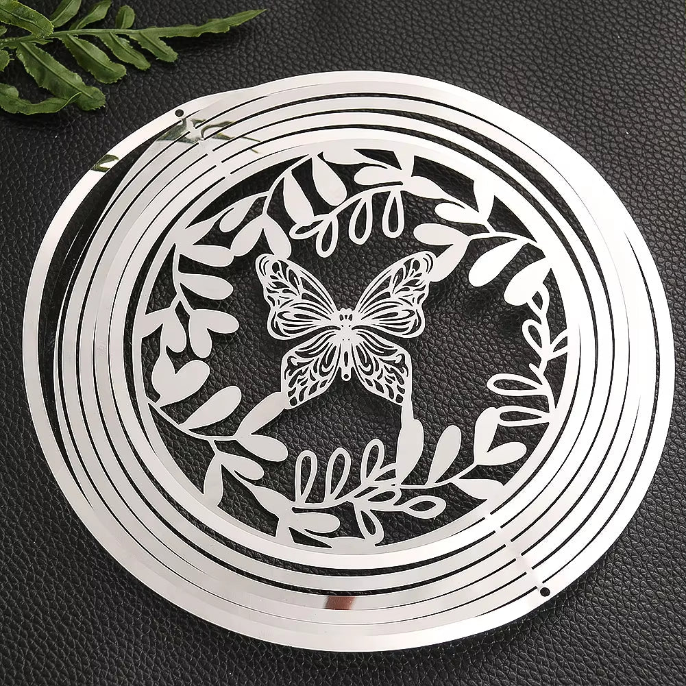 Circular metal wind spinner featuring butterfly and leaf designs for outdoor decor