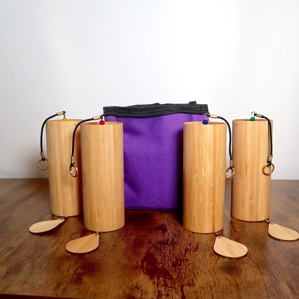 Bamboo wind chimes with purple fabric centerpiece in a protective case set