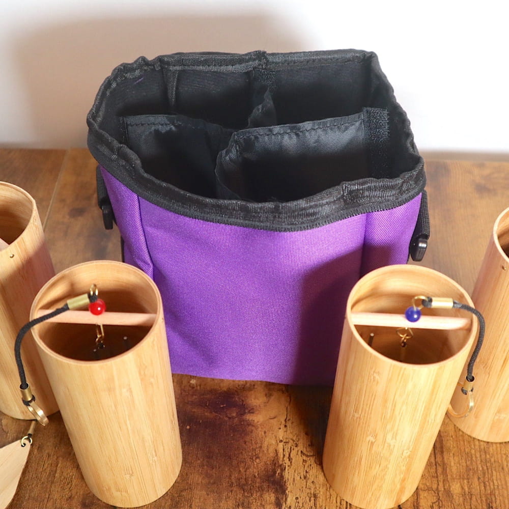 Purple fabric storage pouch with black trim and compartments for Wind Chime Set