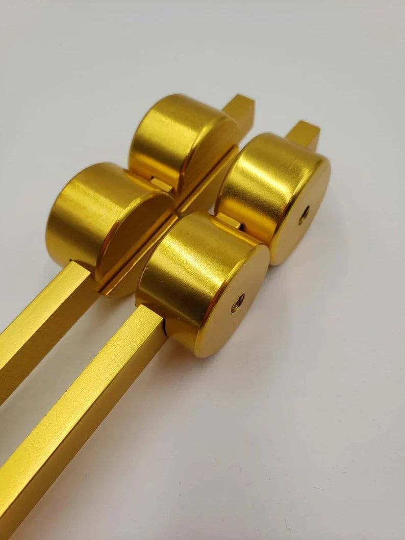 Gold metal rollers on parallel bars for 50 Hz Gold Tuning Fork nerve healing therapy