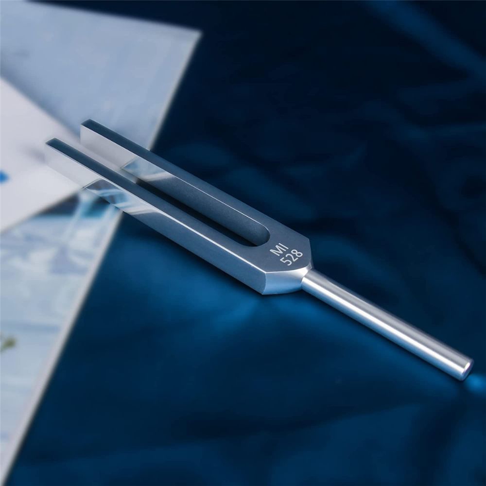 Metal 528 Hz tuning fork with sleek design and resonance box for healing purposes