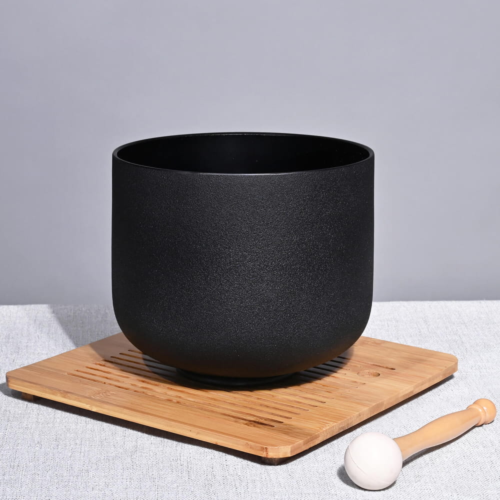 Matte black ceramic bowl on a wooden coaster for 528Hz C Note Black Crystal Singing Bowl