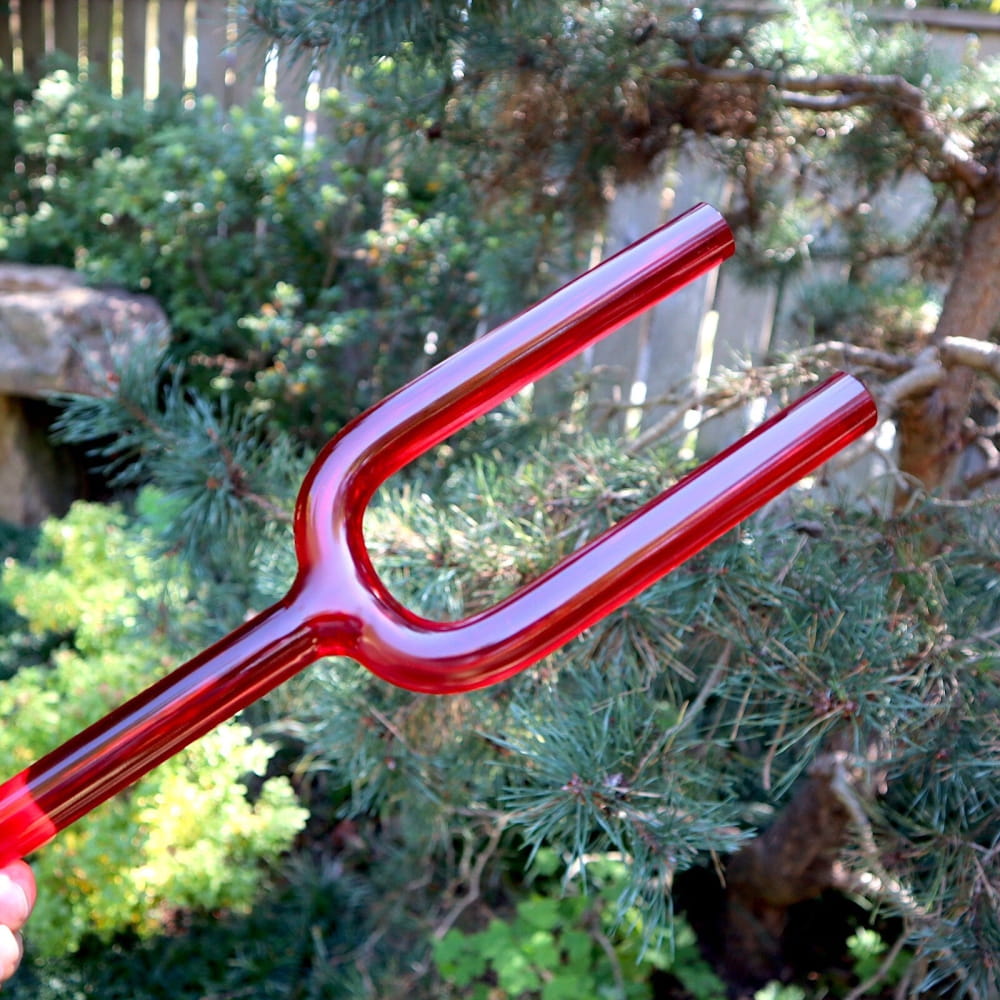 Red metallic pitchfork with two prongs for 528Hz sound healing and chakra therapy