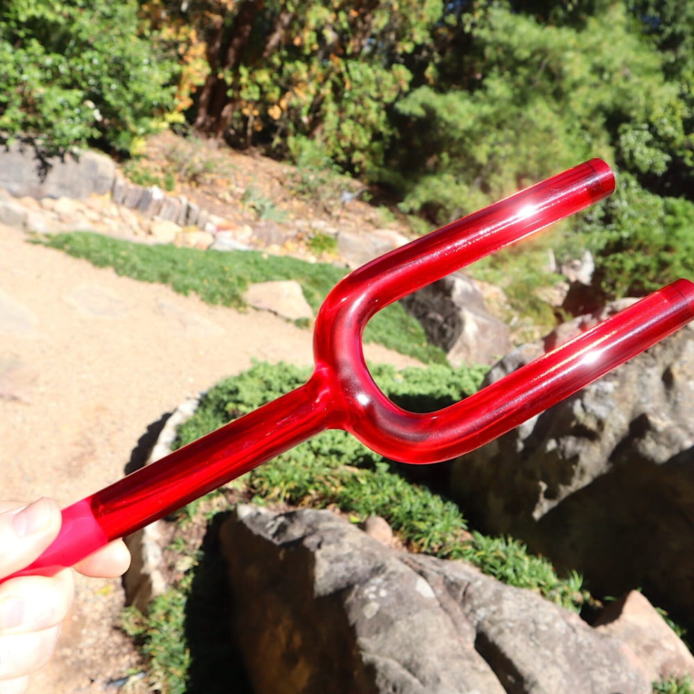 Red plastic garden fork with two prongs for 528Hz Crystal Tuning Fork sound healing