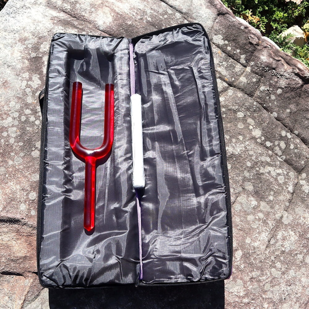 Red and white tuning forks in gray case for 528Hz sound healing and Chakra therapy