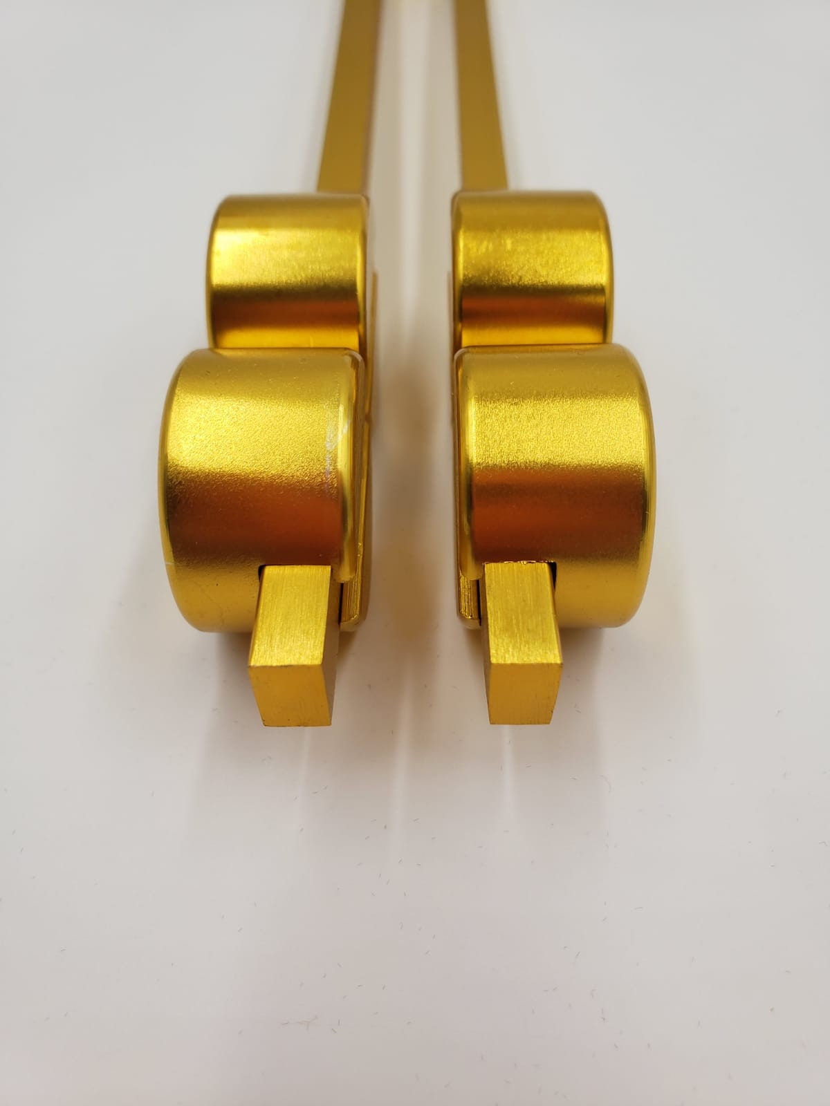 Two gold-colored metallic brackets for 55 Hz Candida Tuning Fork for Healing