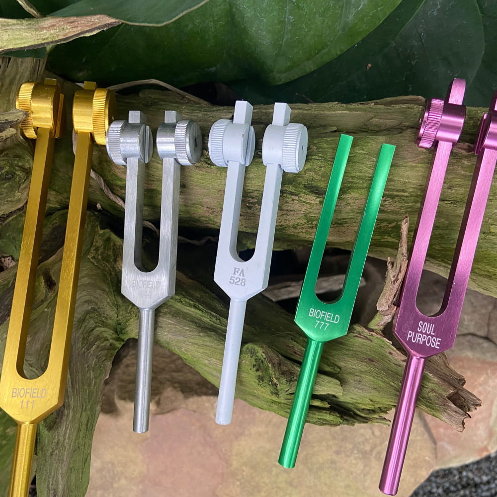 Colorful collection of medical tuning forks for healing and manifestation in 528 Hz