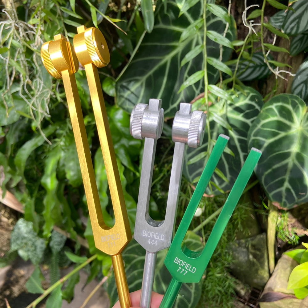 Three tuning forks in gold, silver, and green from the 5pc Tuning Fork Set