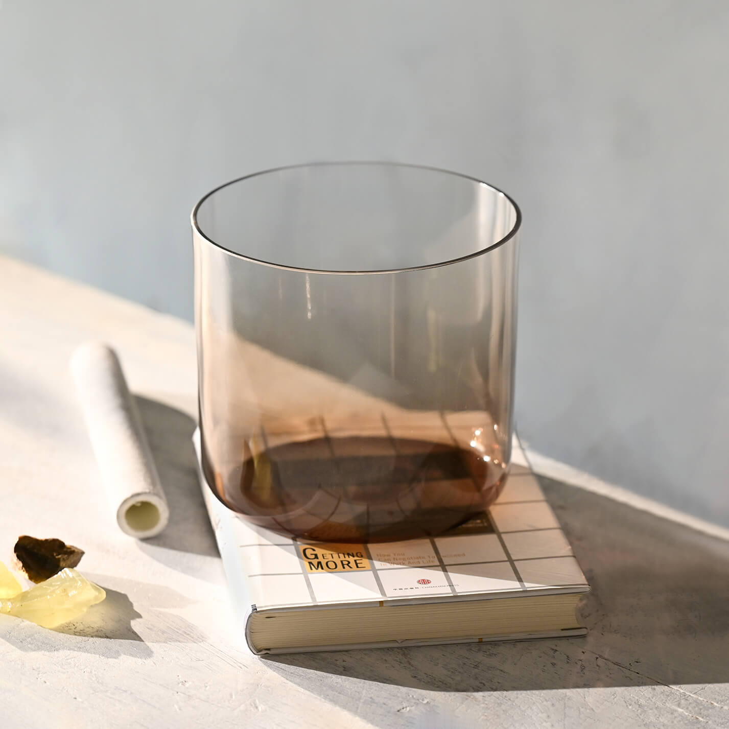 Smoky glass tumbler with dark liquid next to Quartz Crystal Singing Bowl for Meditation