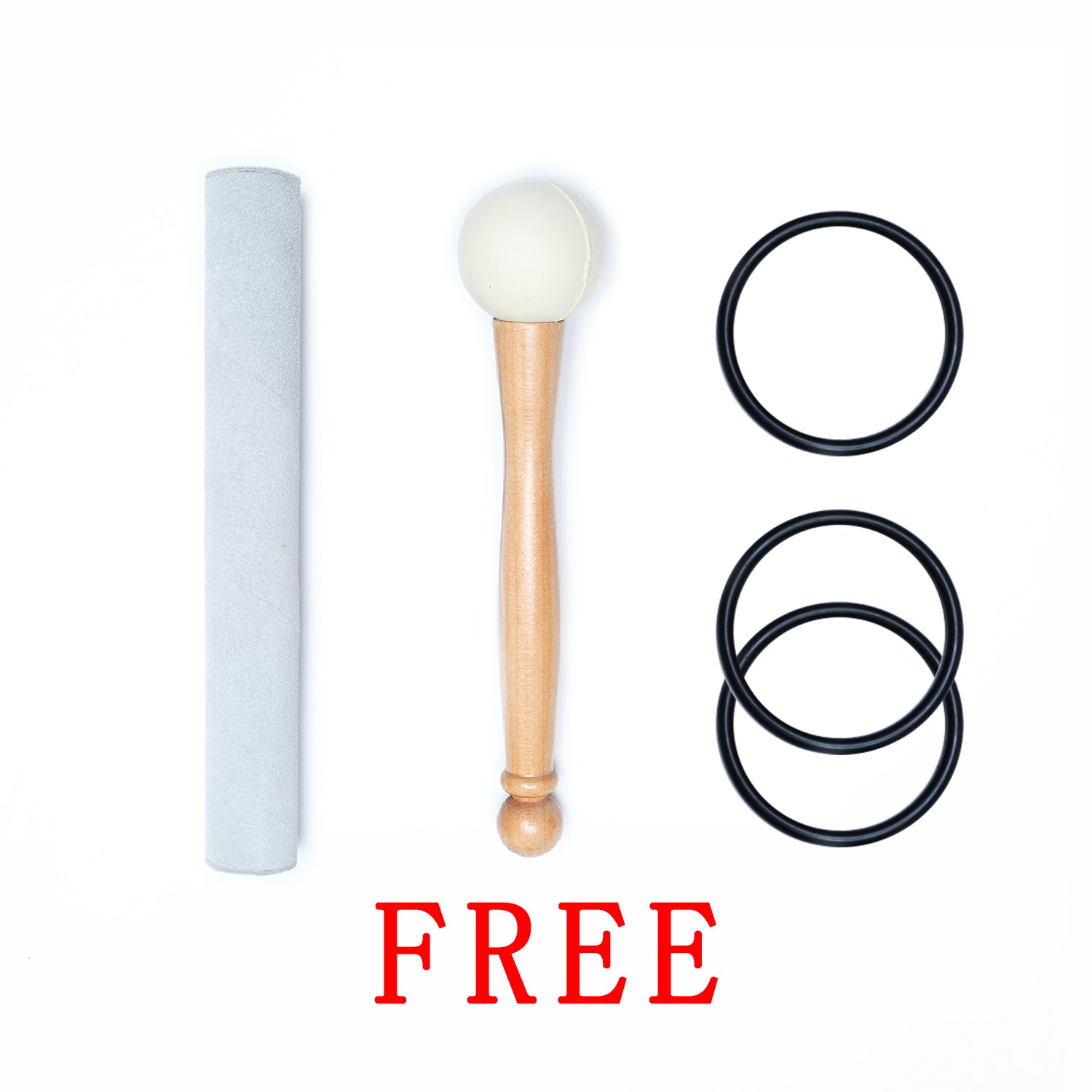 Makeup brush with white bristles and wooden handle beside rubber bands and tube