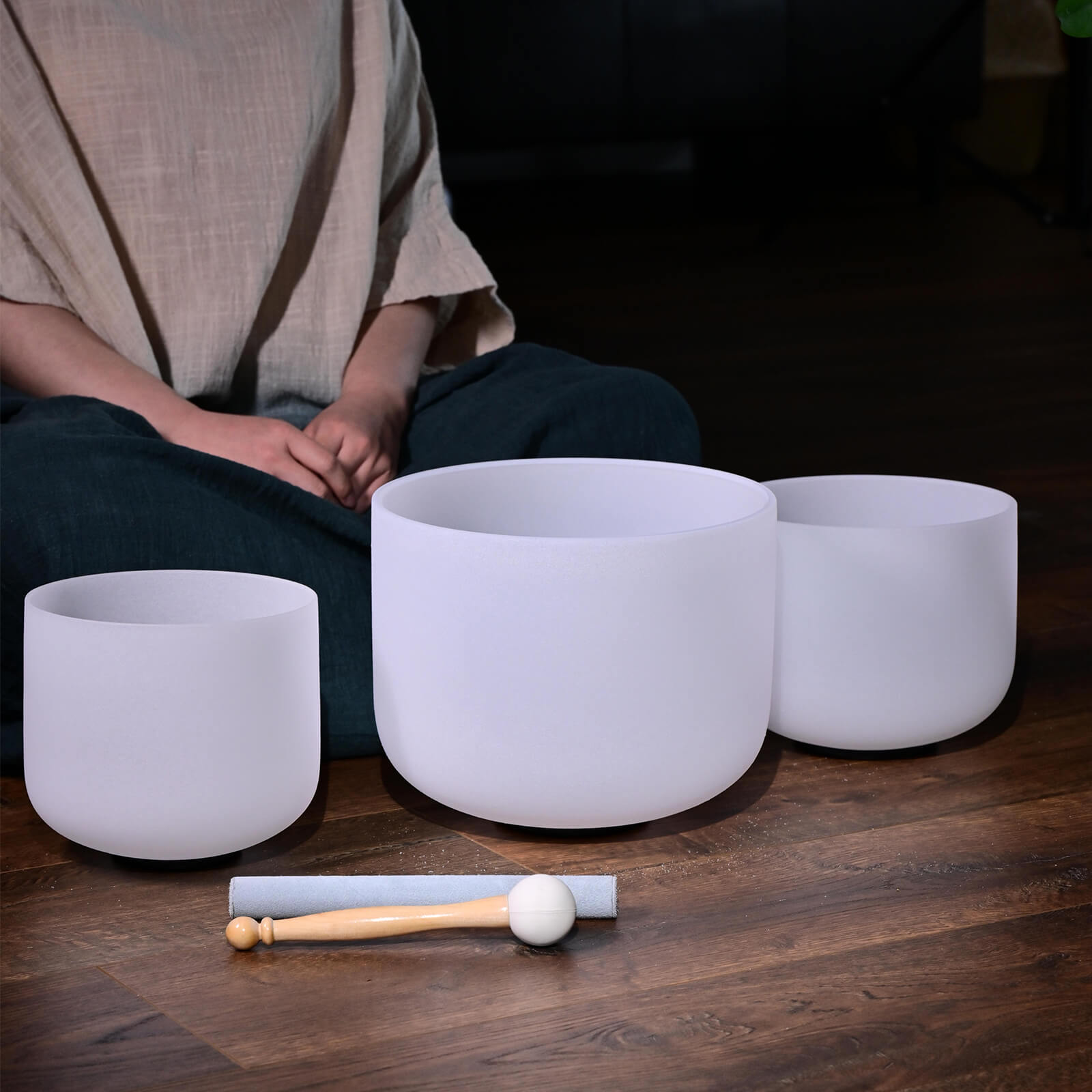 Three white Quartz Crystal singing bowls with a mallet for healing sound baths