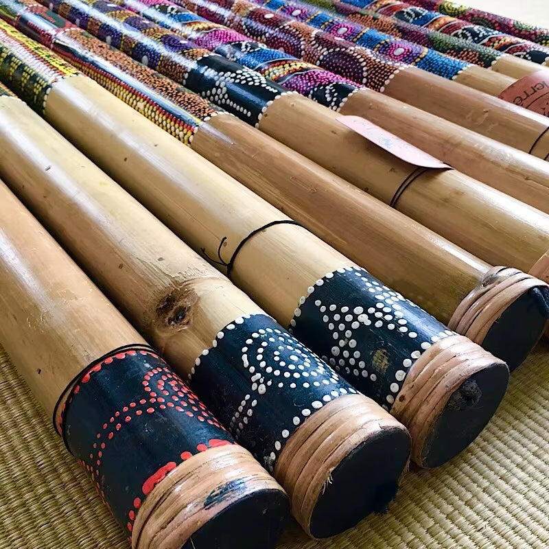 Decorated bamboo rain sticks with vibrant patterns for musical rhythm and decoration