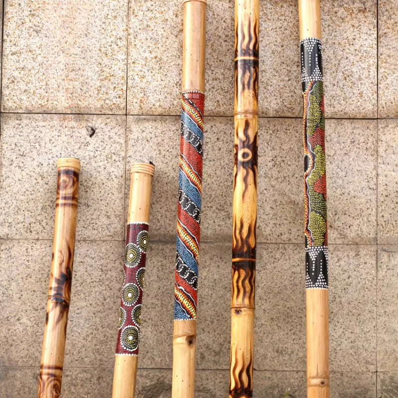 Decoratively painted bamboo rain sticks with colorful patterns for percussion instruments