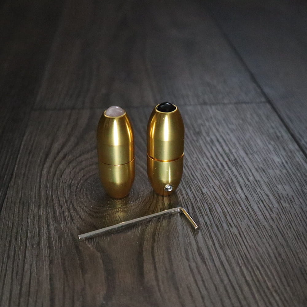 Two brass bullet cartridges with a metal pin for 68.05 Hz Tuning Fork therapy