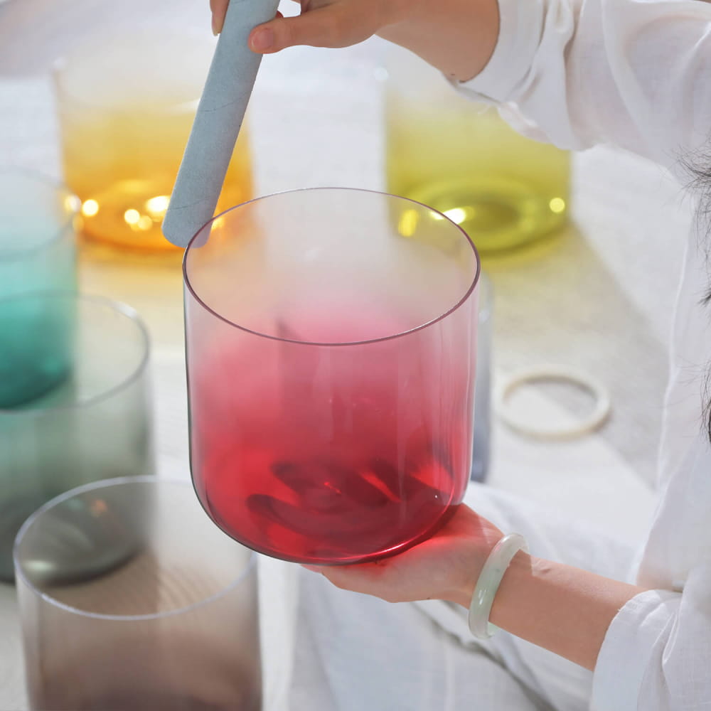 Glass beaker with red liquid stirred by a blue rod in Alchemy Aria Crystal Singing Bowl Set