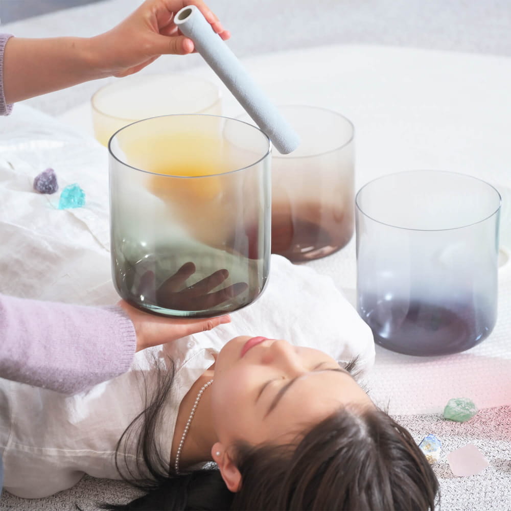 Crystal singing bowl in use during a sound healing session with 7 PCS Alchemy Aria set