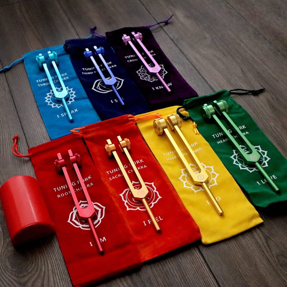 Colorful drawstring pouches with tuning fork designs in a rainbow pattern for sound therapy