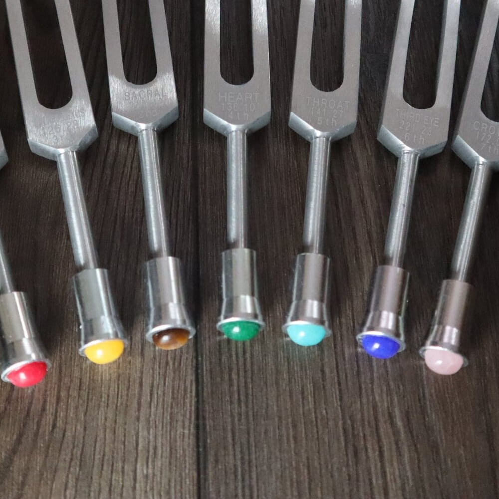 Chakra Tuning Fork Gemstone Attenuator 7pc Set with colored tips in a row