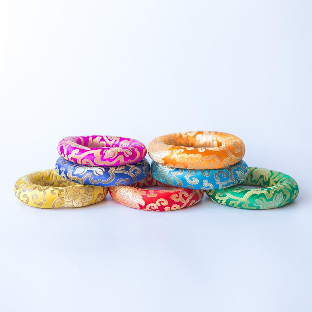 Colorful bangle bracelets with ornate brocade patterns stacked for meditation relaxation