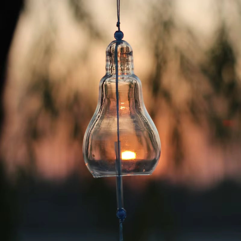 Clear glass light bulb pendant showcasing a glowing sunset, perfect for home decor