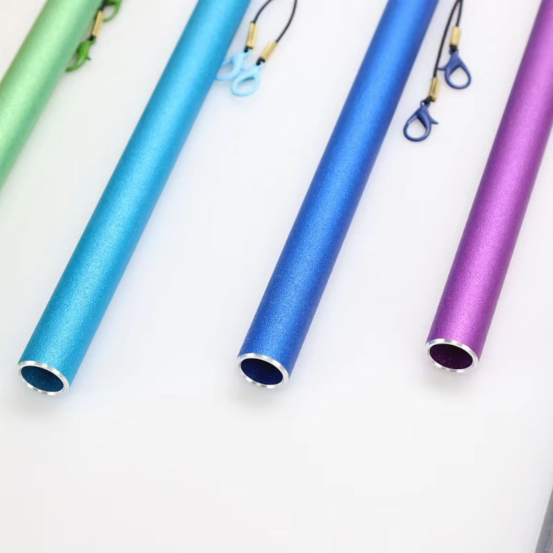 Colorful metallic drinking straws arranged in a row with chakra swing chimes