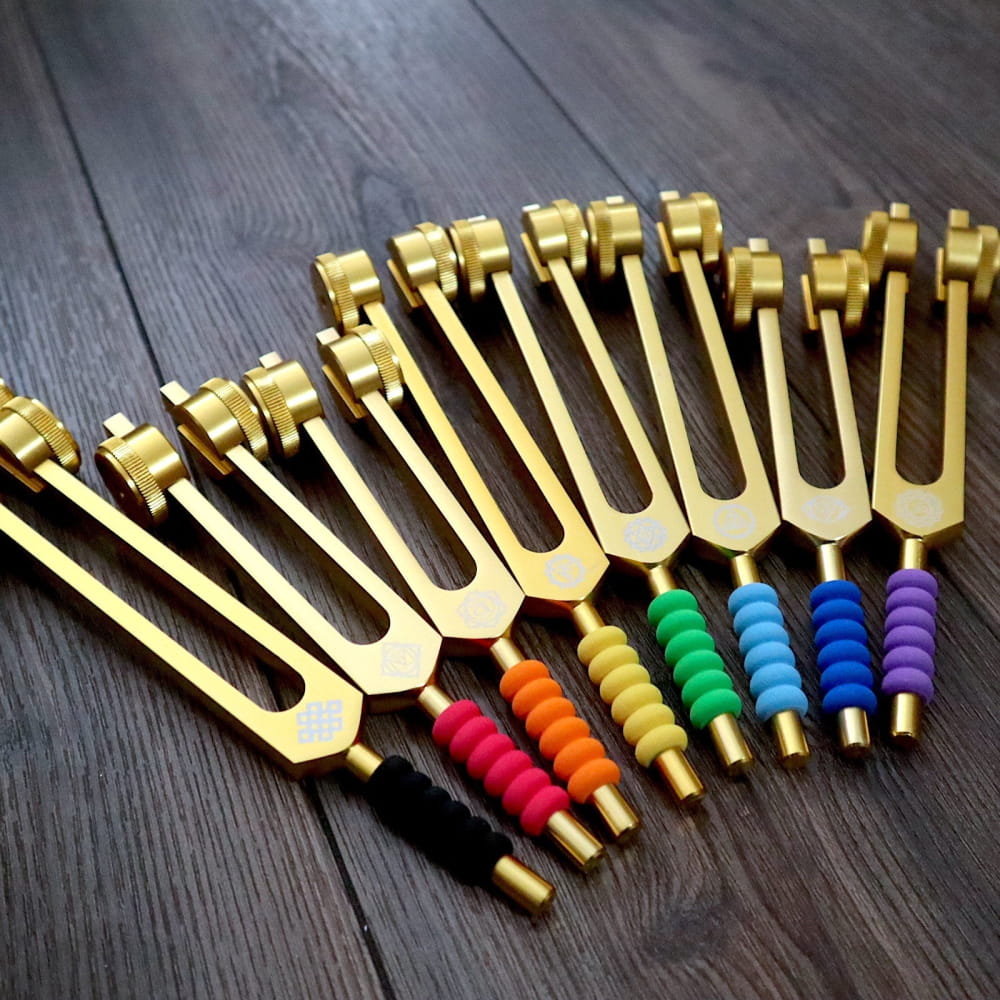 Golden tuning forks with colorful beaded handles in 9-Piece Tuning Fork Grips set