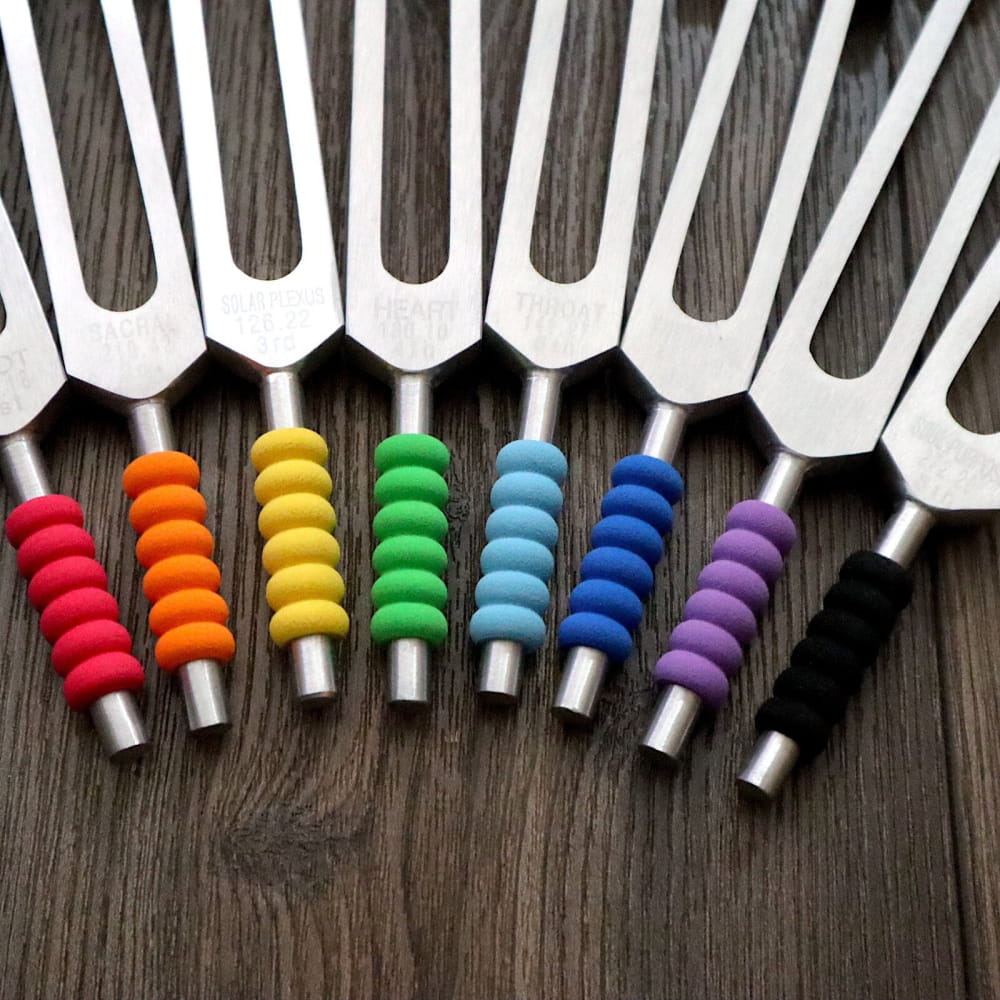 Rainbow-colored tuning forks arranged in a row for 9-Piece Tuning Fork Grips