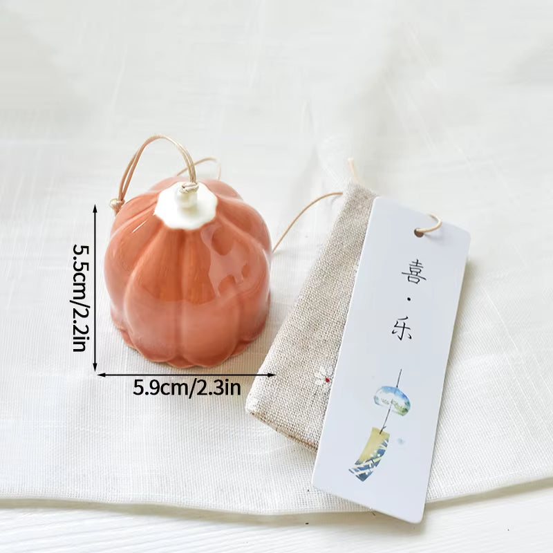 Coral ceramic pumpkin ornament with white stem and gold loop for outdoor decor