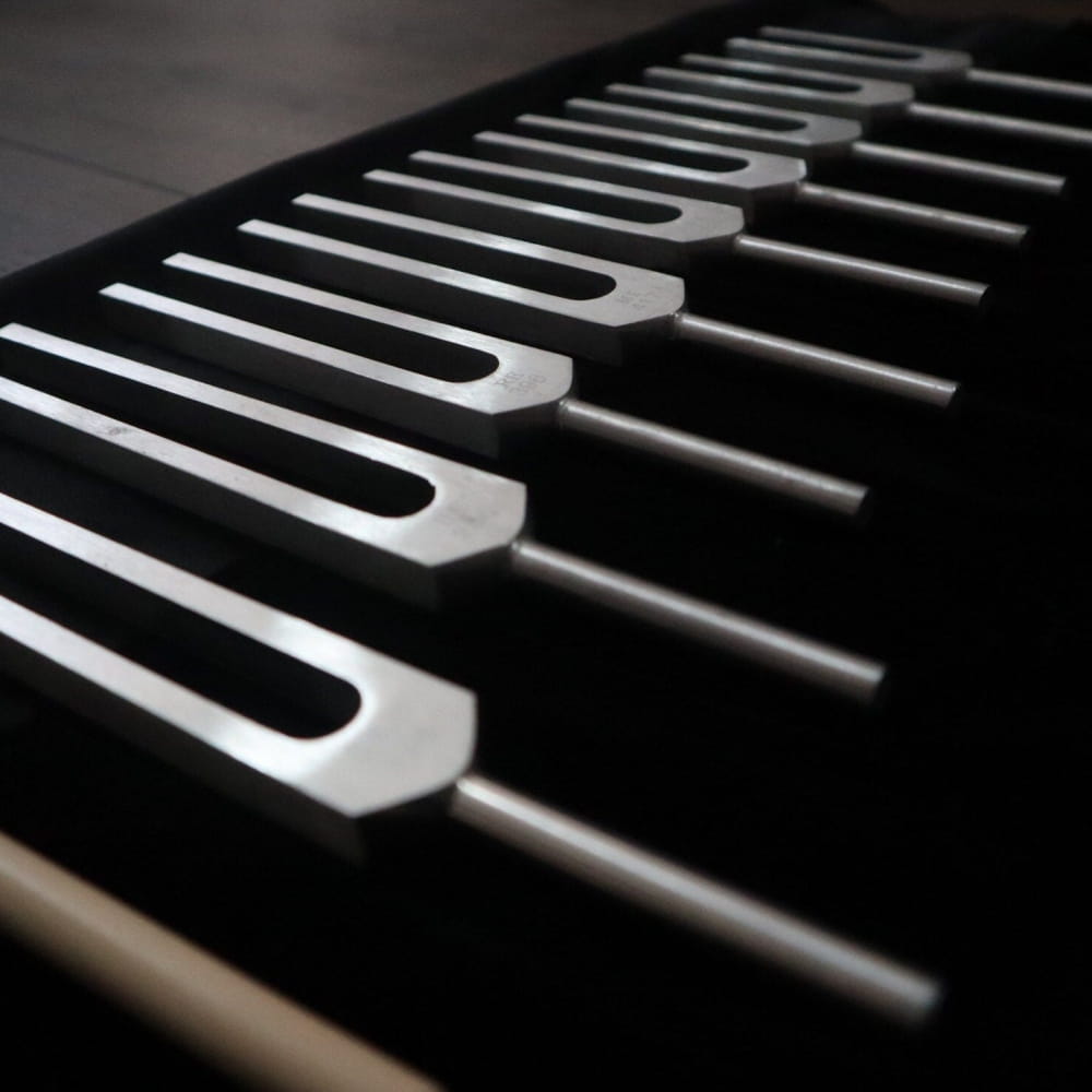 Close-up of black and white piano keys for 9pc Solfeggio Frequencies Set Silver Sound Vibration