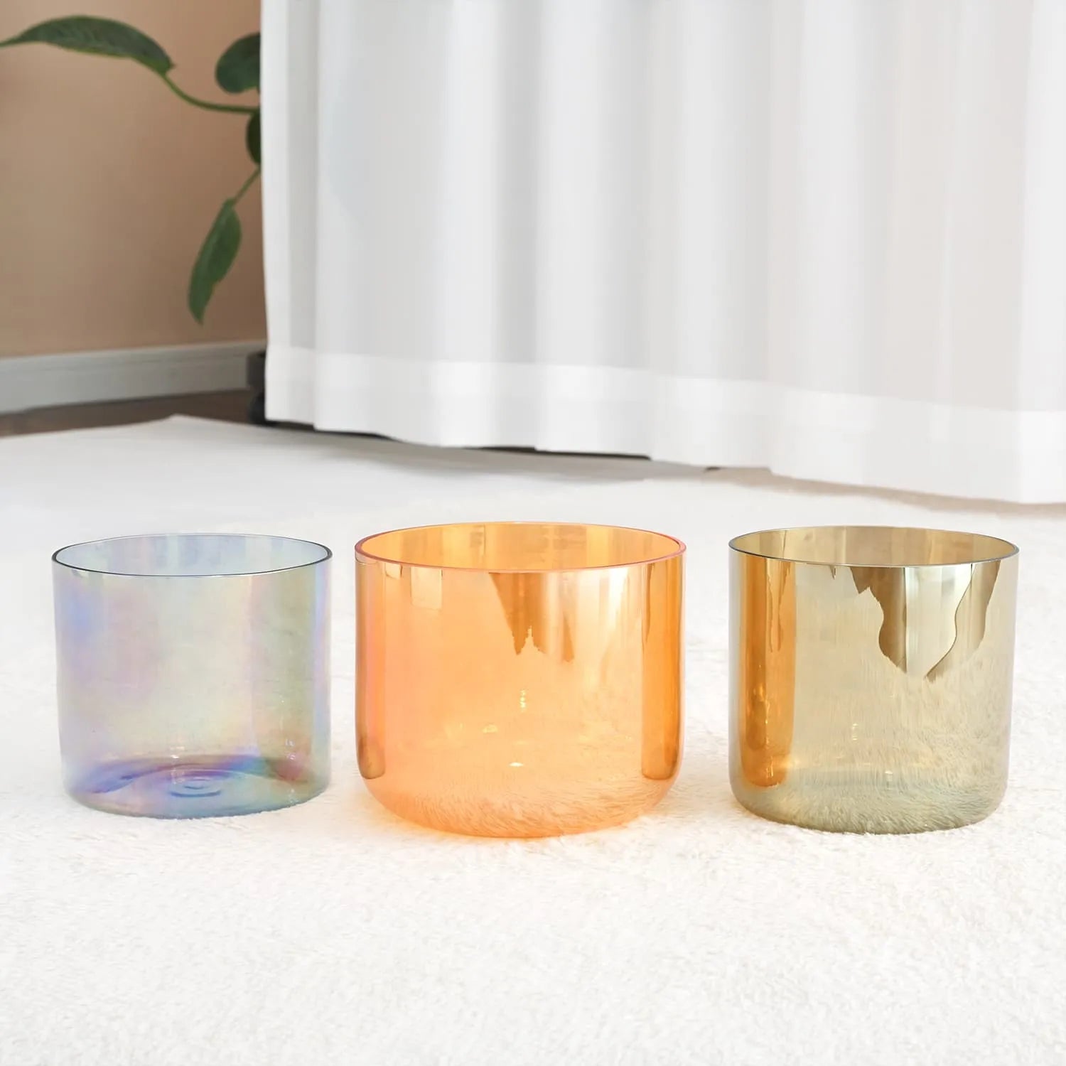 Three iridescent orange and gold crystal singing bowls in a Sound Bath Bowl Set