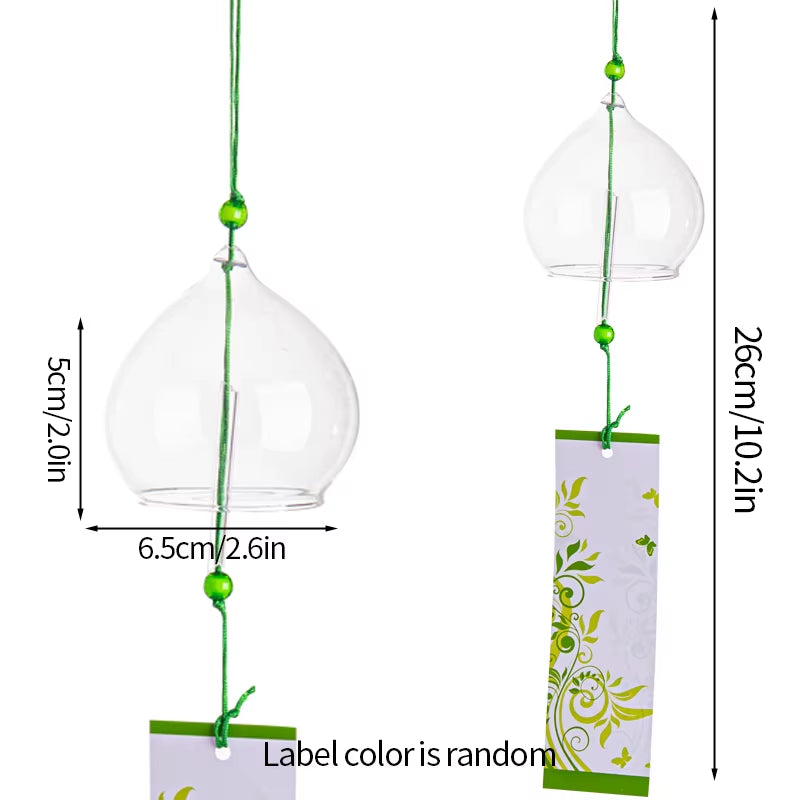 Clear glass bell-shaped wind chime with floral design and green accents for outdoor decor