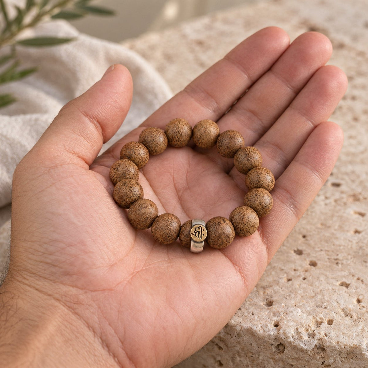 Natural Agarwood Chinese Zodiac Peace Bracelet 12mm Beads, held in the hand to show its real size