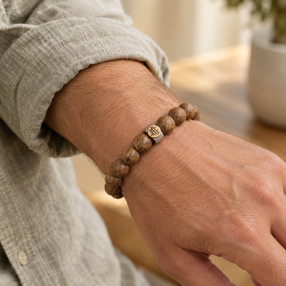 Natural Agarwood Chinese Zodiac Peace Bracelet 12mm Beads, worn on the wrist by a man