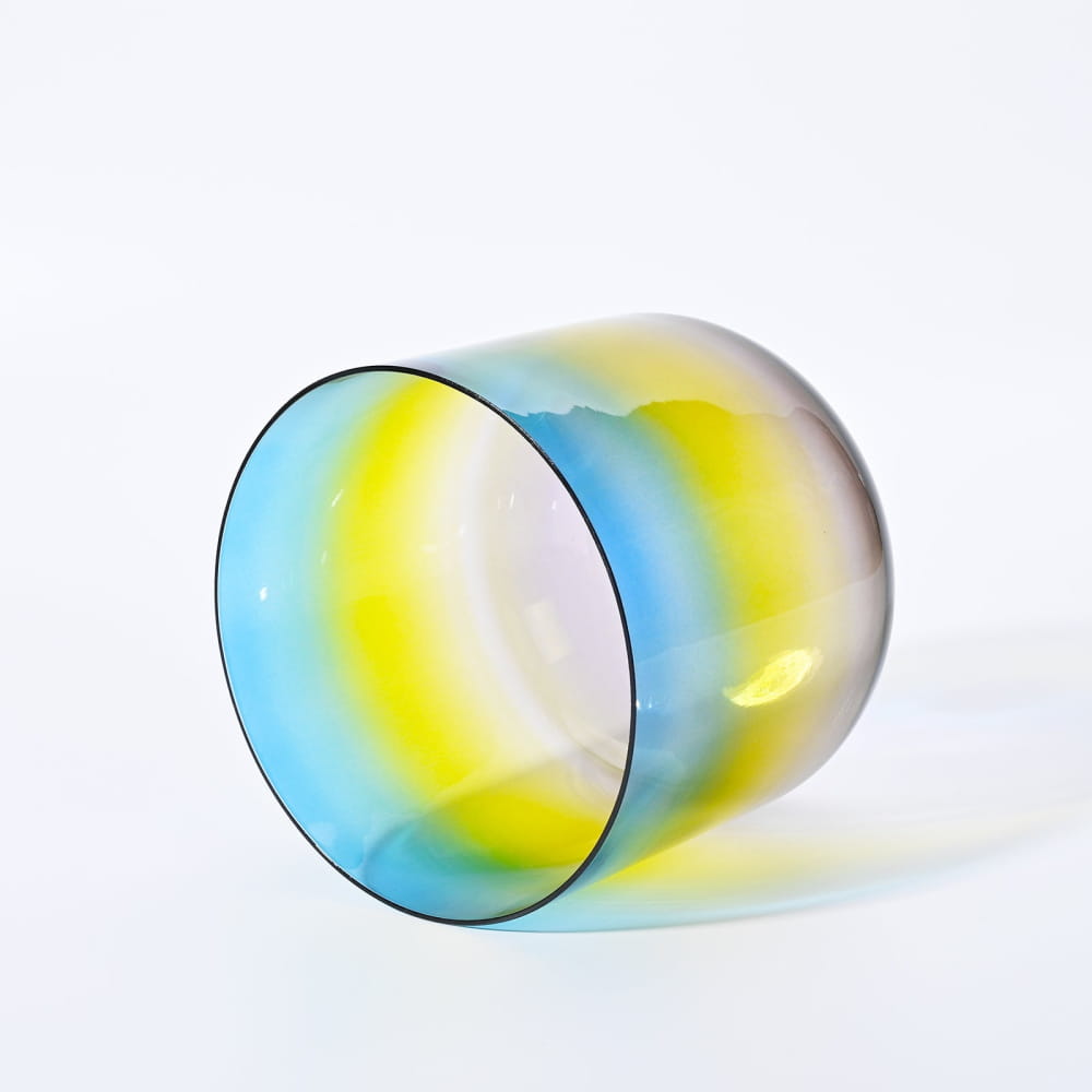 Colorful glass tumbler with blue, yellow, and green hues in Alchemy Clear Rainbow product