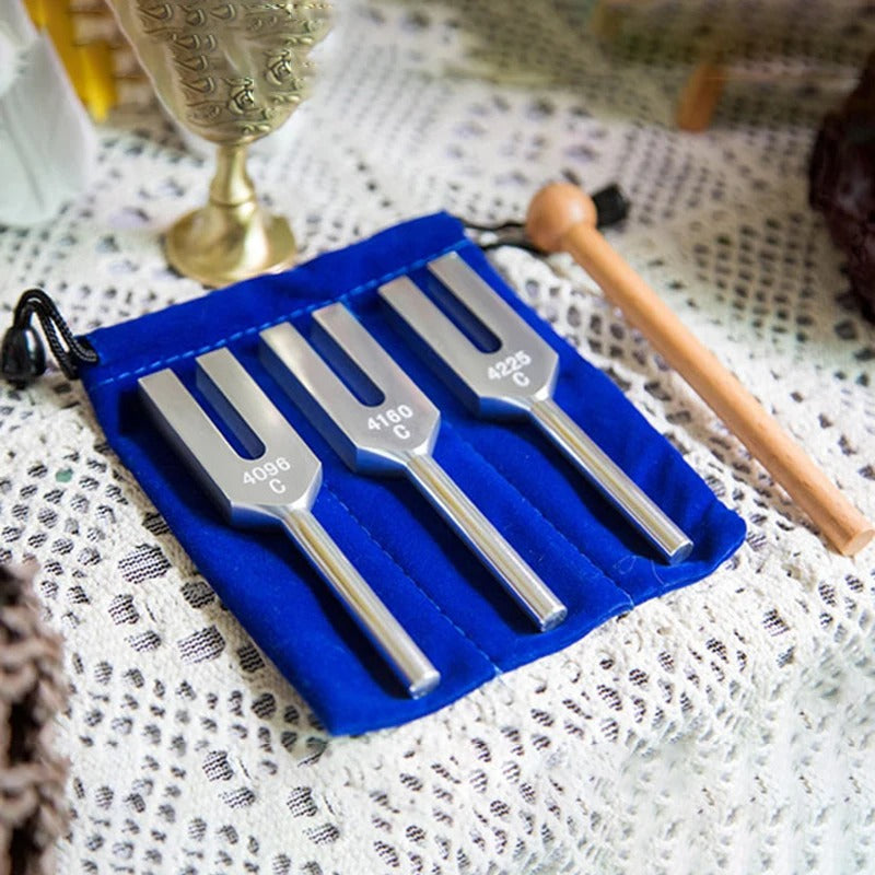 Three Angel Tuning Forks in a blue velvet case with a wooden mallet for healing therapy