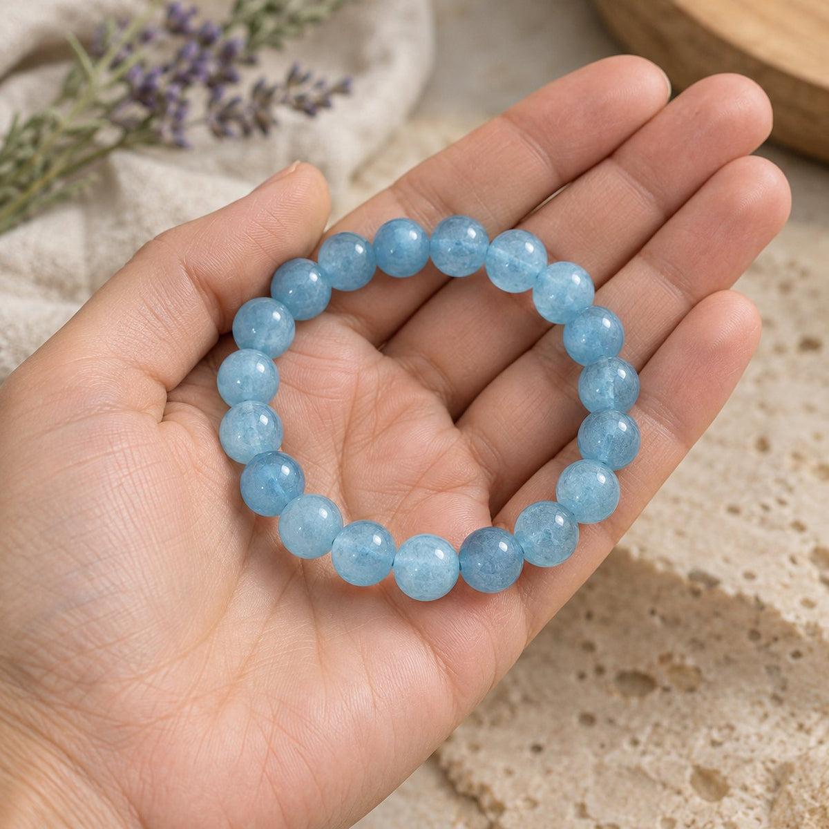 8mm Aquamarine Healing Beads Peace Bracelet, held in the hand to show its real size