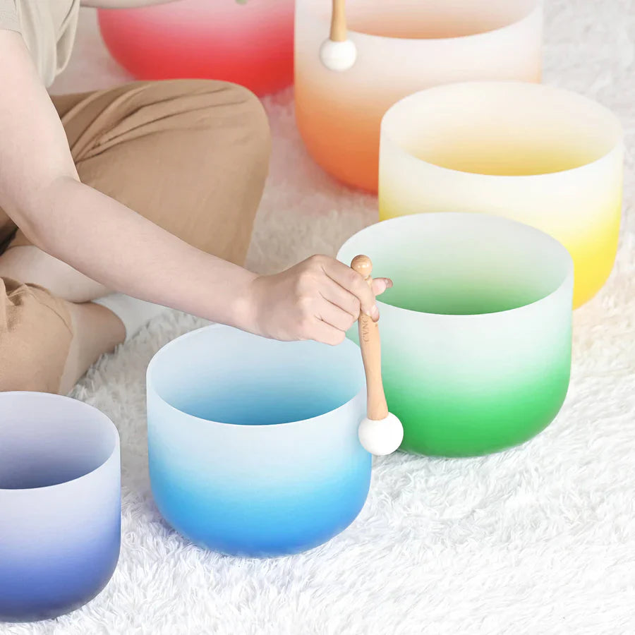 Frosted crystal singing bowls in rainbow colors with wooden mallet from Aria set