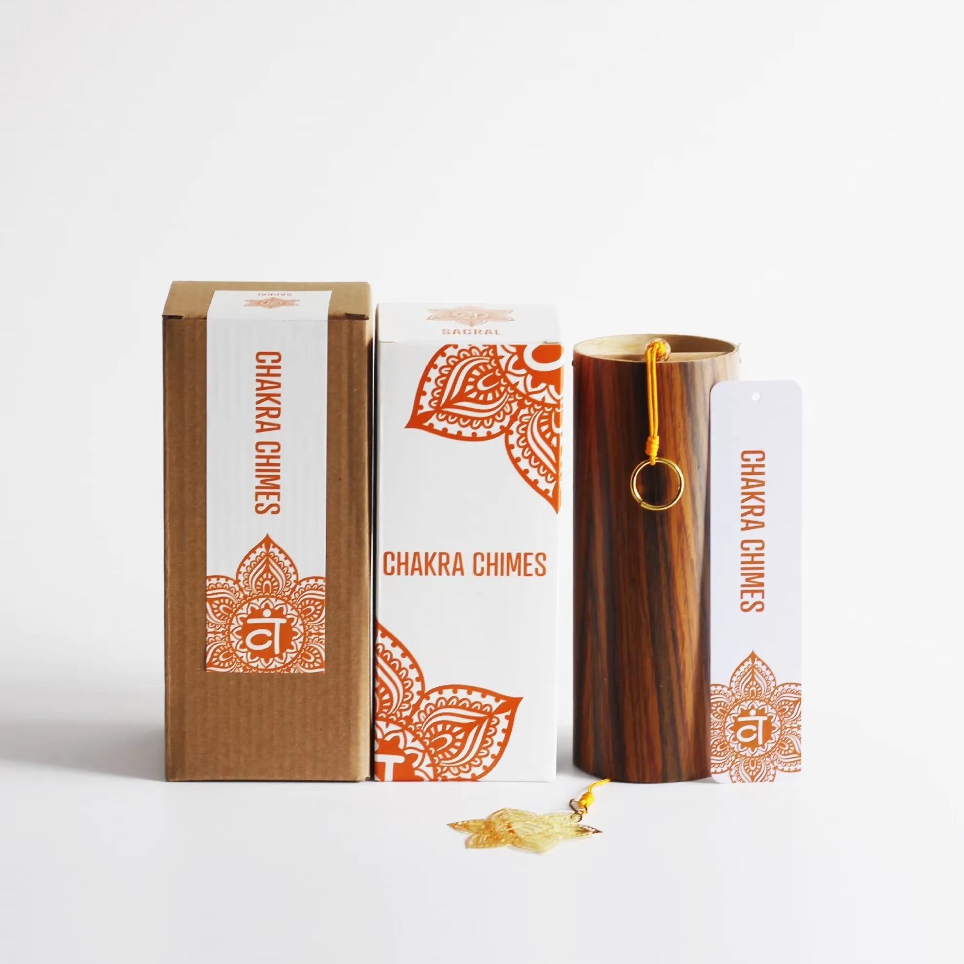 Wooden chime tube with orange mandala chakra-themed packaging for Bamboo Koshi Wind Chimes