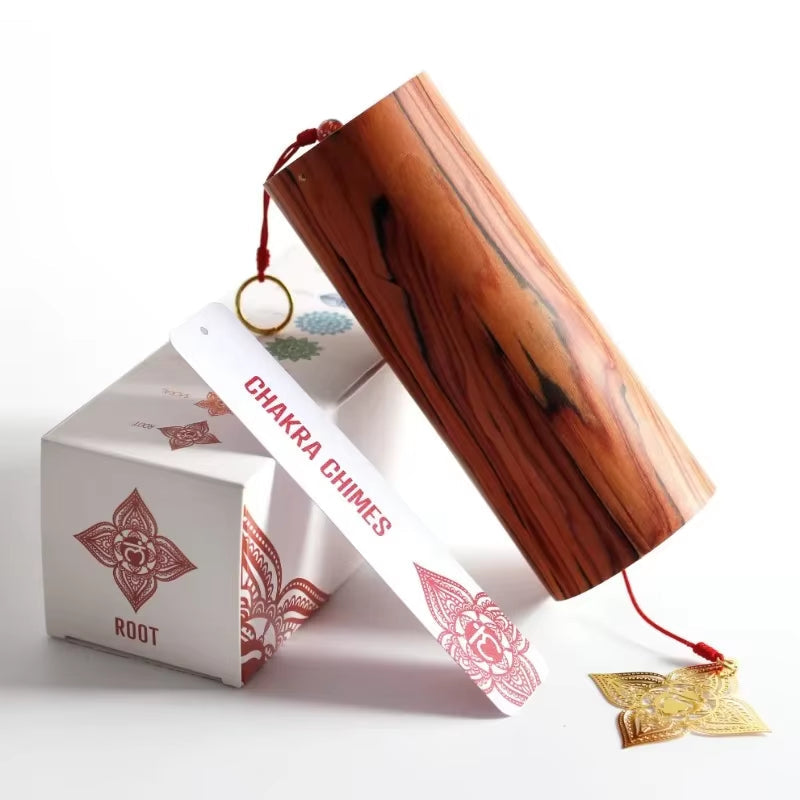 Bamboo Koshi Wind Chimes with red string and gold accents beside patterned box