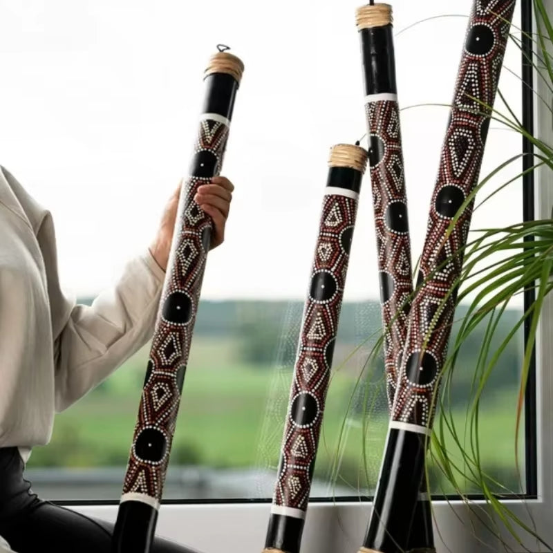 Decorative bamboo didgeridoos with Aboriginal dot painting patterns for healing therapy