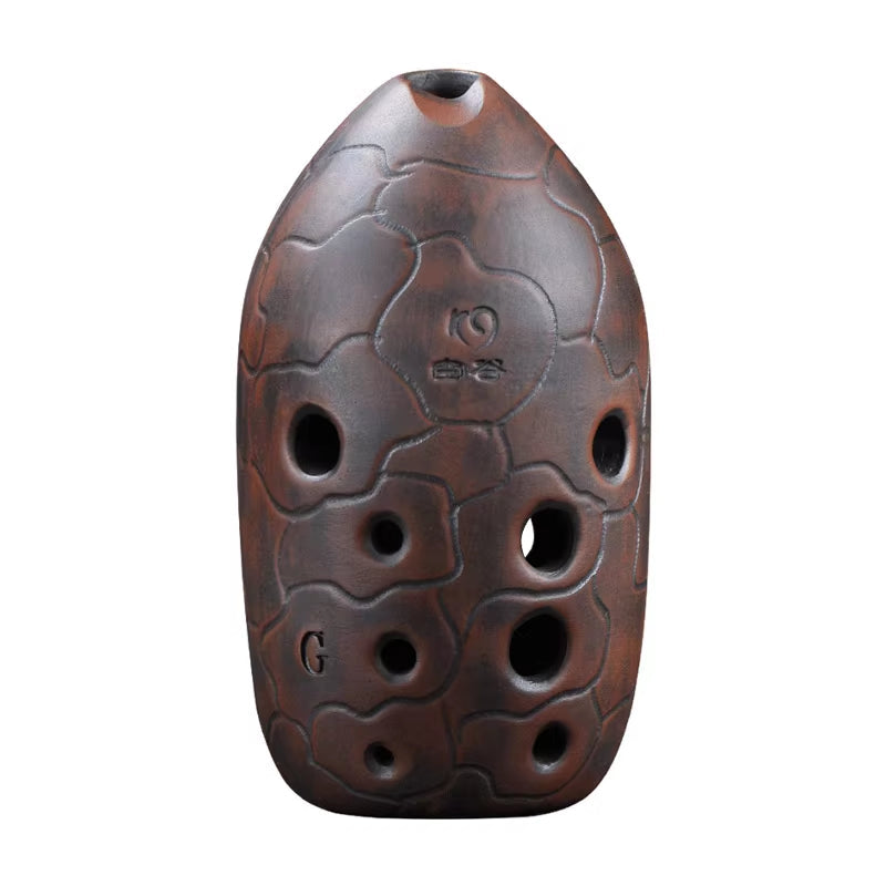 Dark brown ceramic ocarina with finger holes and carved patterns from Beginner Xun Instrument