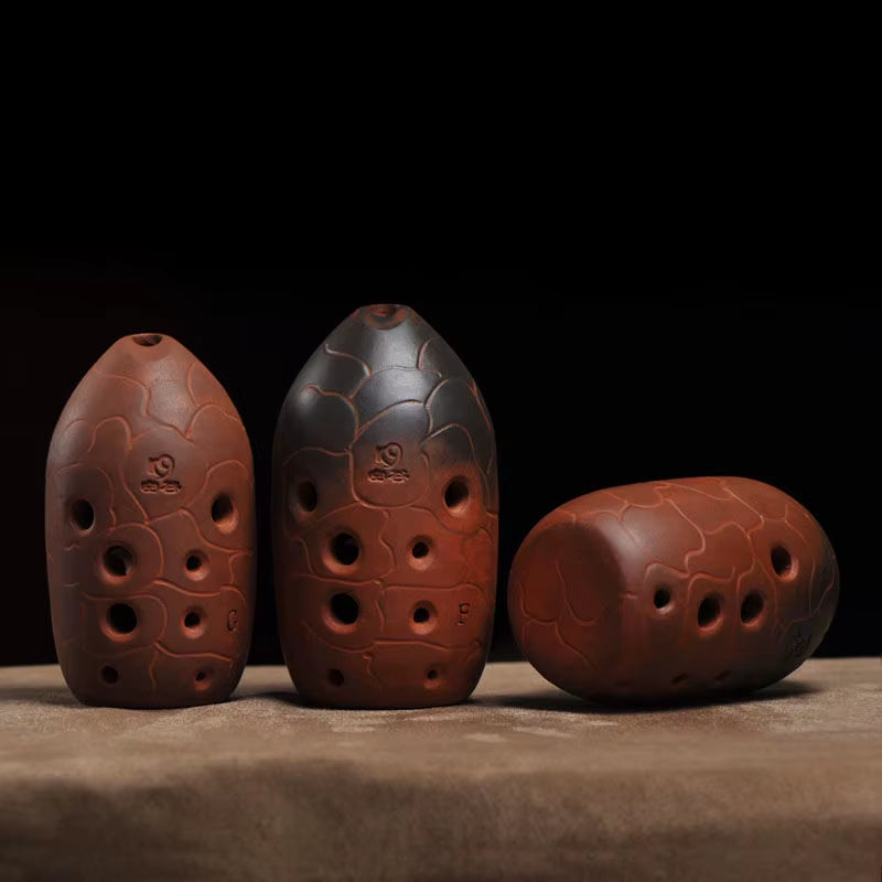 Three decorative clay ocarinas with finger holes from Beginner Xun Instrument