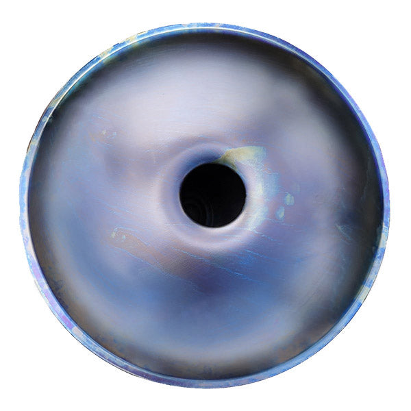 Circular metallic ring with black hole center and blue-gray iridescent color on Handpan Drum